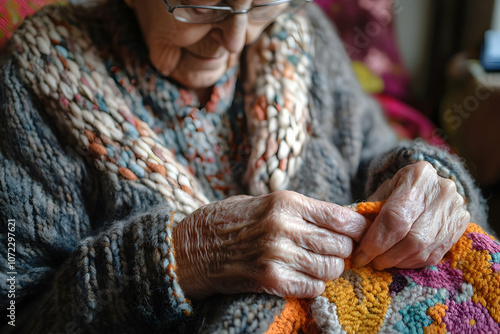 An elderly woman lovingly stitches a colorful quilt in her cozy living room