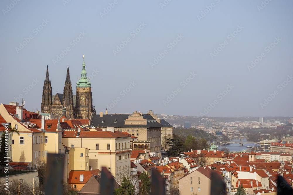 view of the old town church and buildings with red tiled roofs against a blue sky background view of the old town church and buildings with red tiled roofs against a blue sky background