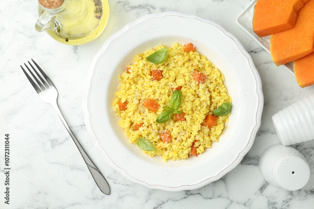 Delicious pumpkin risotto served on white marble table, flat lay Delicious pumpkin risotto served on white marble table, flat lay