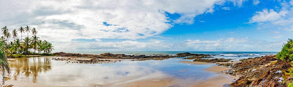Deserted beach hidden between rocks and coconut trees in the town of Serra Grande on the coast of Bahia, northeastern Brazil Deserted beach hidden between rocks and coconut trees in the town of Serra Grande on the coast of Bahia, northeastern Brazil