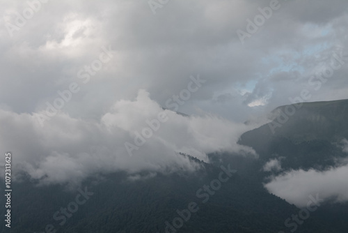 Misty mountains at dawn, shrouded in a soft veil, create a magical atmosphere of tranquility and mystery of nature photo