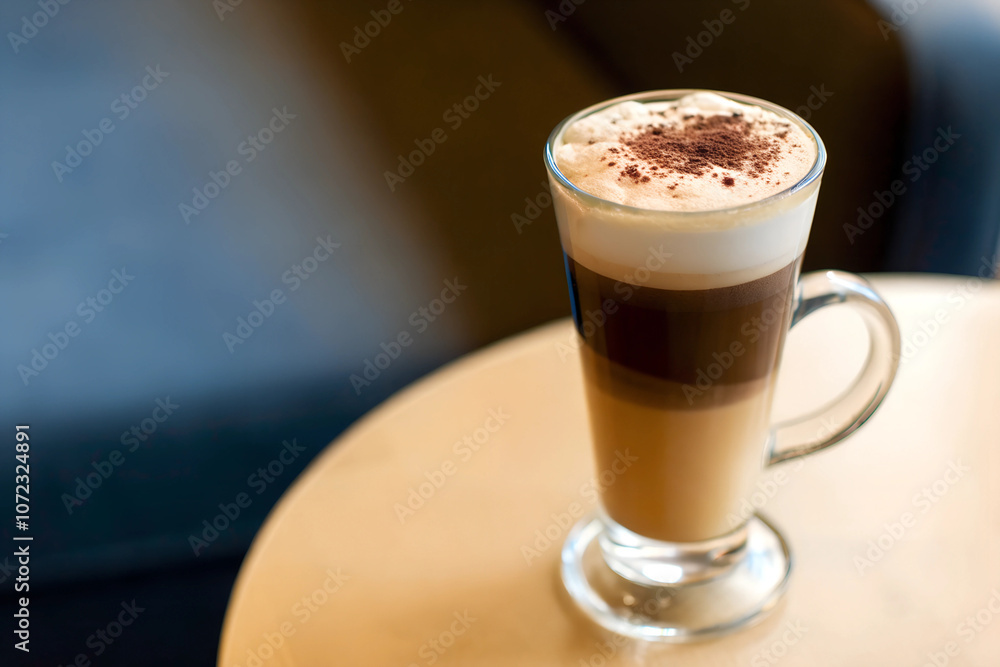 Melange coffee in a glass with beautiful layers, topped with frothy milk and sprinkled cinnamon, embodying a cozy, warm cafe feel.