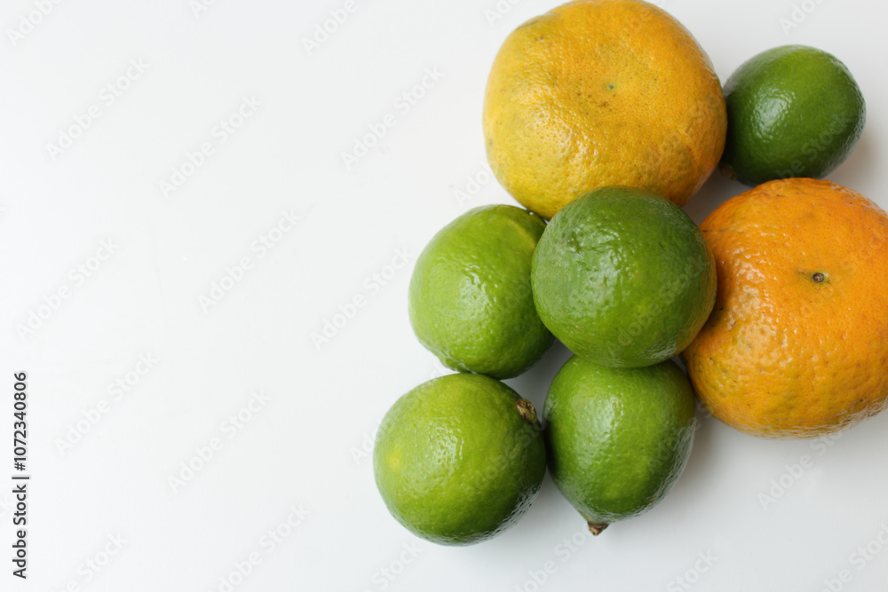 Organic oranges and limes on white background for vegan diet. Brazilian tropical fruits. Antioxidants and vitamins for healthy vegetarian meal. Organic oranges and limes on white background for vegan diet. Brazilian tropical fruits. Antioxidants and vitamins for healthy vegetarian meal.