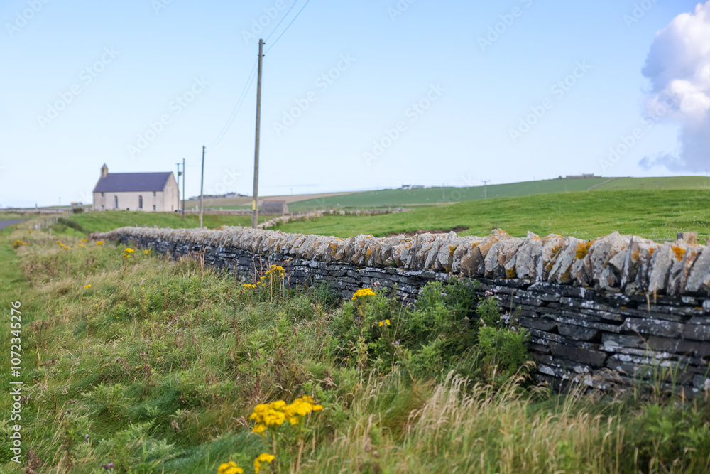 Obraz premium Orkney, Scotland - August 6, 2024: Stone walls on the island of Orkney in Scotland