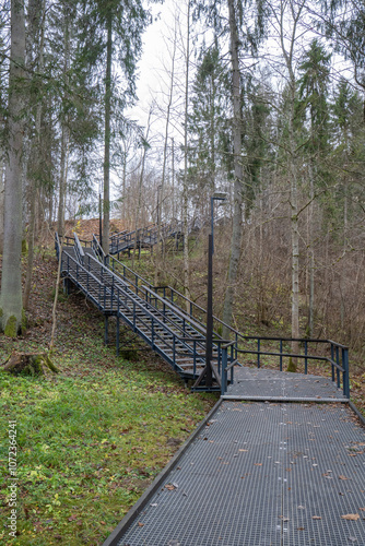 The photo shows a long modern iron staircase. made of stainless steel grid. suitable for the park. photo