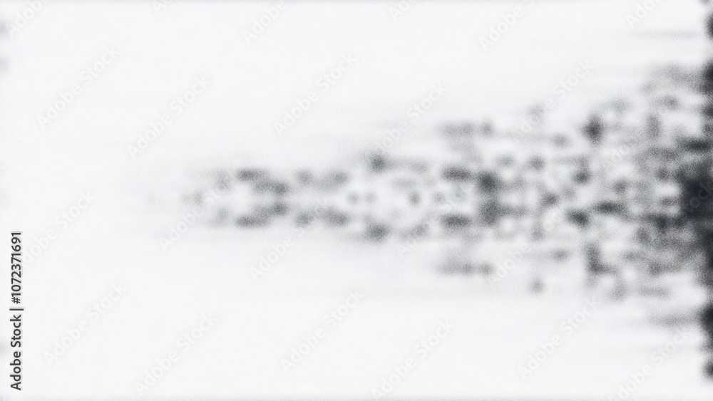Fototapeta premium Mottled black, grey, and white background with a grainy, distorted texture, creating a rough noise effect suitable for banners and backgrounds.