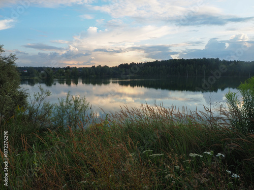 Obraz na płótnie Beautiful summer landscape with lake and forest in the background at sunset w salonie