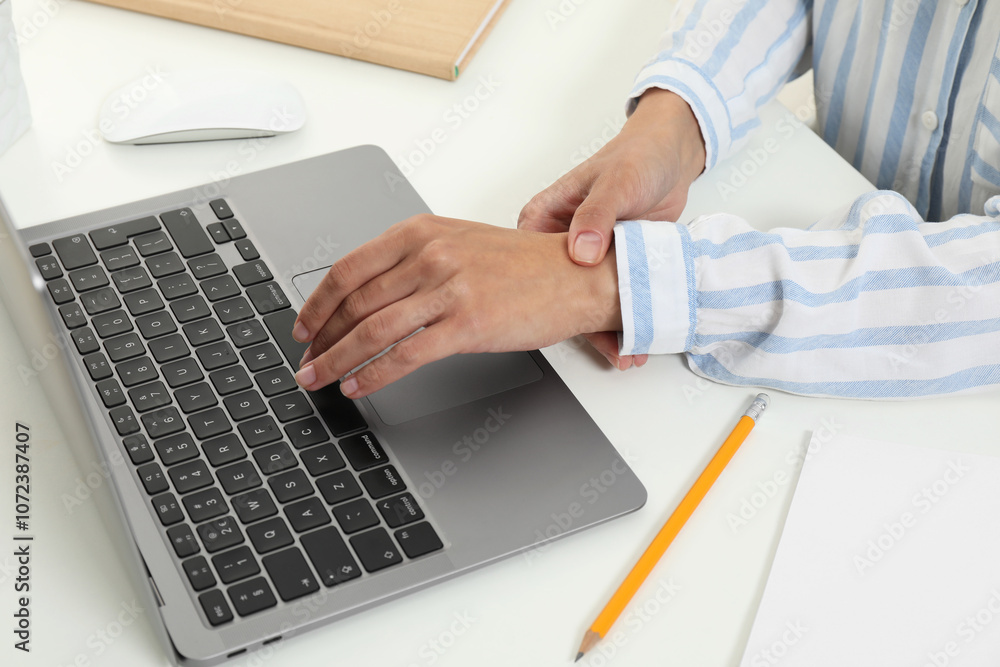 Carpal tunnel syndrome. Woman suffering from pain in wrist at desk, closeup Carpal tunnel syndrome. Woman suffering from pain in wrist at desk, closeup