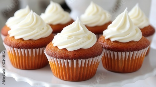 Delicious vanilla cupcakes with creamy frosting on white backdrop