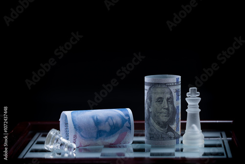 100 dollars and 100 Turkish lira , Economic war on the chessboard. Fictional shooting and custom focus adjustable. photo