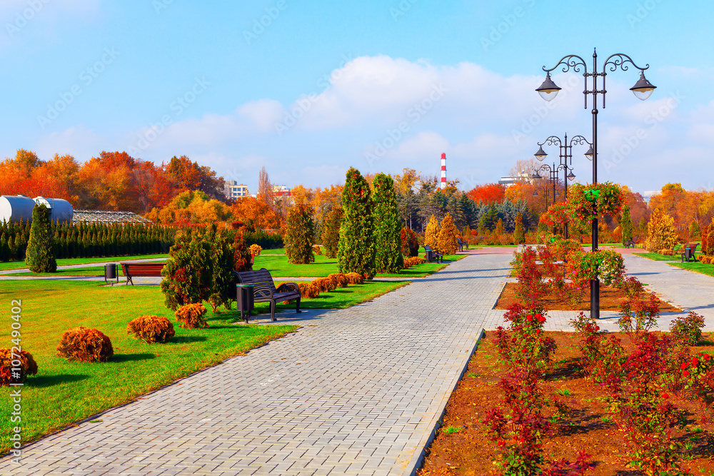 Serene park scene featuring benches under a light post. Dendrariu Park from Chisinau Moldova in Autumn season