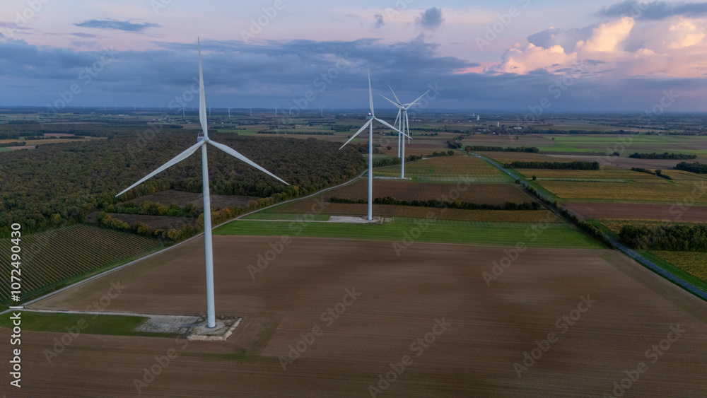 Aerial View of Large Wind Turbines Over Farmland at Dusk Aerial View of Large Wind Turbines Over Farmland at Dusk