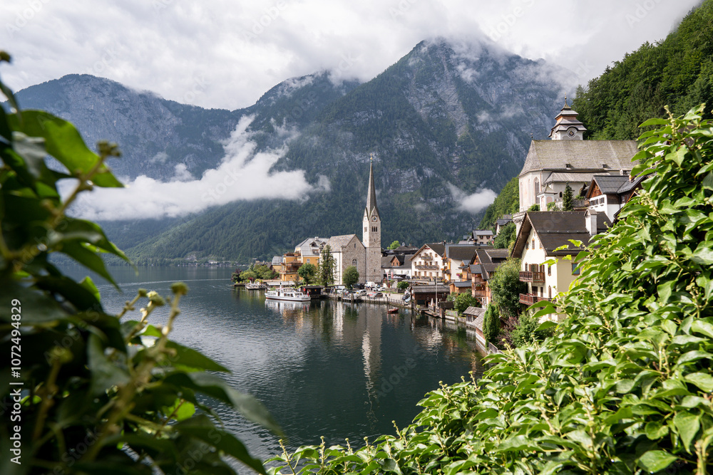 Fototapeta premium Morning view of famous picturesque Hallstatt village and cloudy mountains on Hallstatt lake, Gmunden, Austria