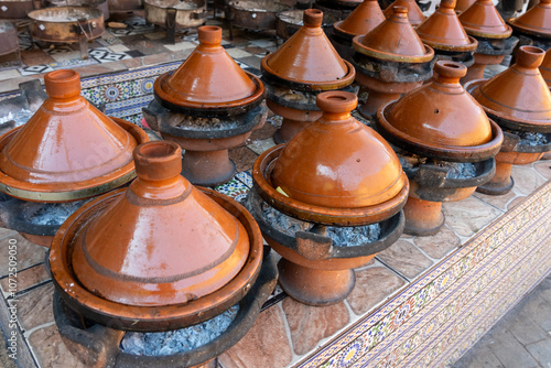 Moroccan ceramic Tajines cooked on burning hot coals in a restaurant in Morocco. 
 photo