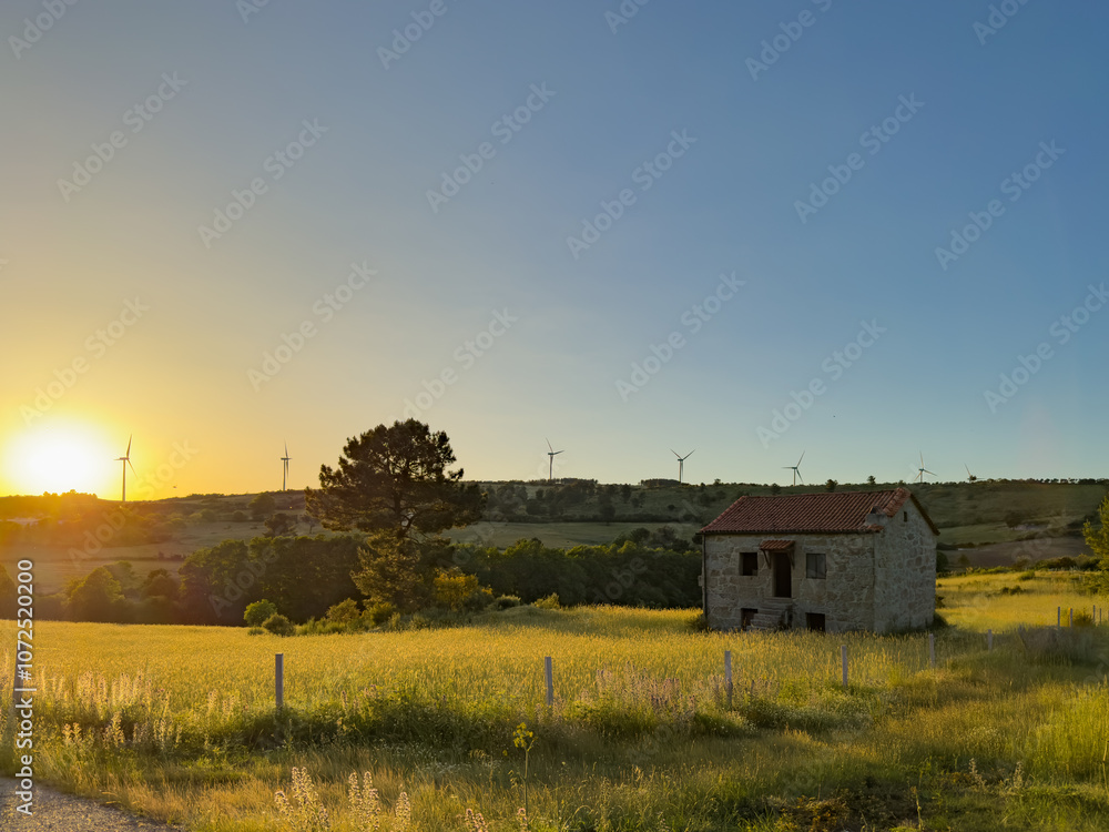 Golden sunset casting a warm glow over a serene village nestled among rocky hills and lush greenery. Linhares da Beira, Portugal Golden sunset casting a warm glow over a serene village nestled among rocky hills and lush greenery. Linhares da Beira, Portugal