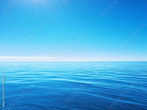 Clear blue ocean and sky under bright sunlight on a tranquil day, perfect for relaxation and contemplation at sea