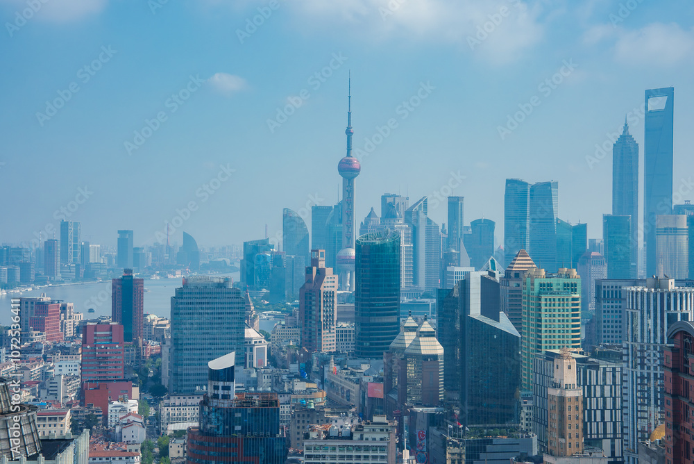 Fototapeta premium View of Shanghai's skyline featuring the Oriental Pearl Tower, The Bund, and modern skyscrapers like the Shanghai World Financial Center.