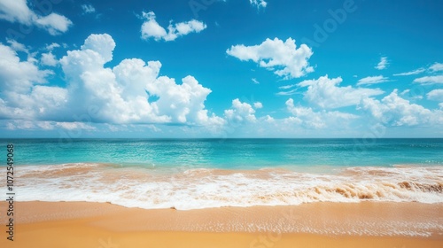 Golden sand beach meeting turquoise water under a blue sky with white clouds