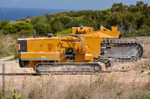 Wallpaper Mural Powerful Trencher Machine on a Coastal Landscape, with sea View on backgtound  Torontodigital.ca