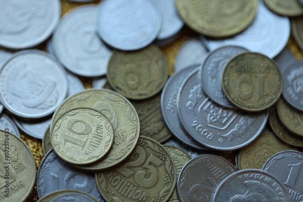 Metal coins of Ukraine of different denominations are scattered. Money texture, business background. Metal coins of Ukraine of different denominations are scattered. Money texture, business background.