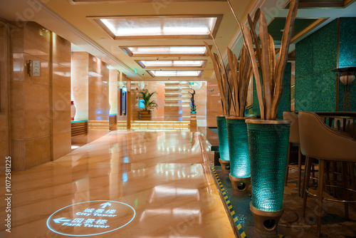 Photography The image shows a luxurious lobby in Shanghai with polished marble floors, decorative planters, and modern art