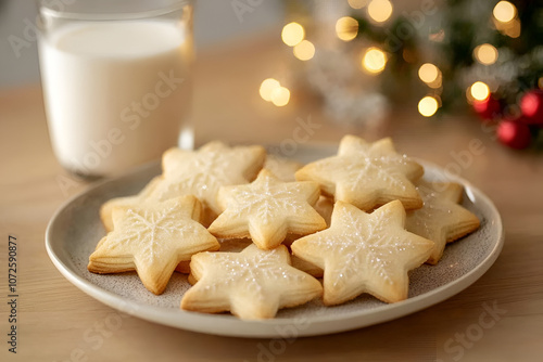 Delicious star-shaped cookies with intricate icing designs accompany a glass of milk on a beautiful decorative plate, evoking cozy holiday and festive feelings.