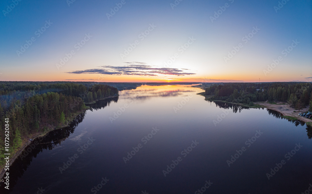 Aerial top view to island in summer evening during white nights. Vuoksa lake river and channels system leaking in Finland and Russia flowing into Ladoga. Romashki village, Leningrad region, karelia. Aerial top view to island in summer evening during white nights. Vuoksa lake river and channels system leaking in Finland and Russia flowing into Ladoga. Romashki village, Leningrad region, karelia.