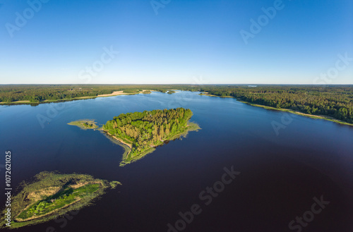 Aerial top view to island in summer evening during white nights. Vuoksa lake river and channels system leaking in Finland and Russia flowing into Ladoga. Romashki village, Leningrad region, karelia. photo