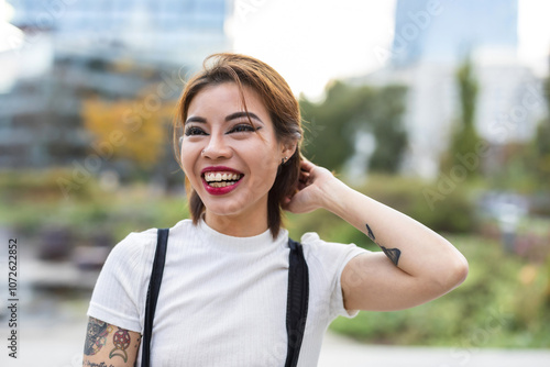 Portrait of a smiling young woman in the city
