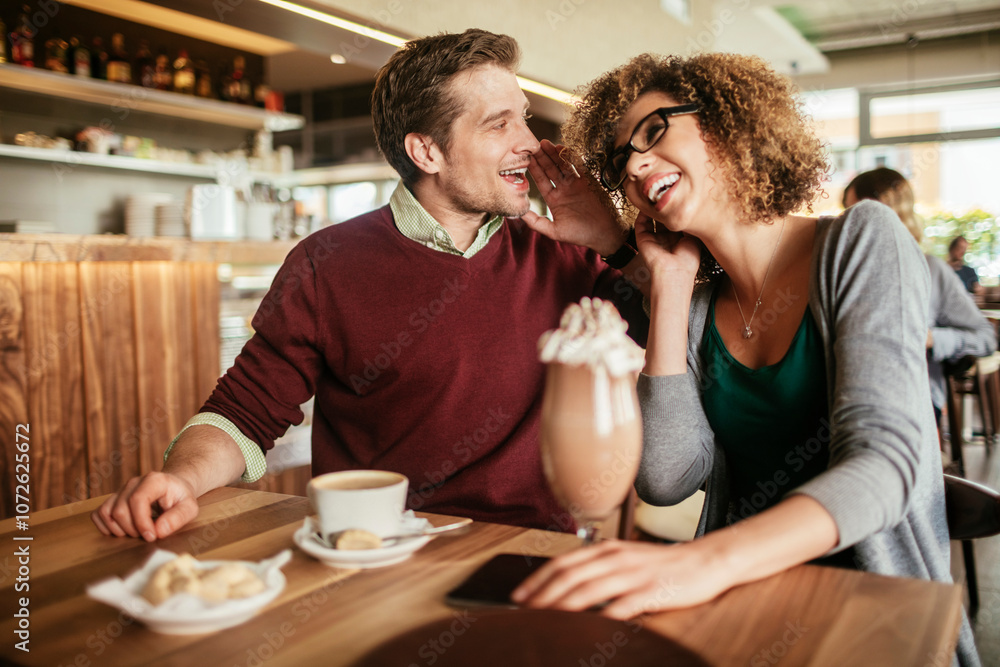 Young couple having a cup of coffee together in a cafe Young couple having a cup of coffee together in a cafe