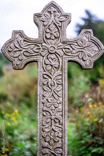 An ornate cross with intricate floral patterns etched into its design