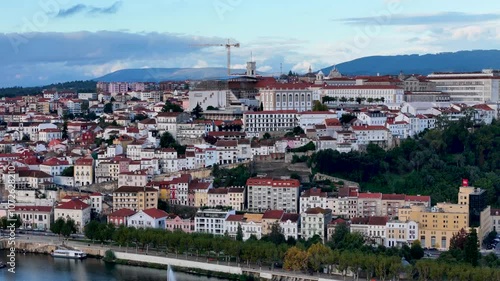 4K drone video footage of Coimbra city old town on the hill. Panoramic aerial cityscape of Coimbra university and Mondego River, Portugal
