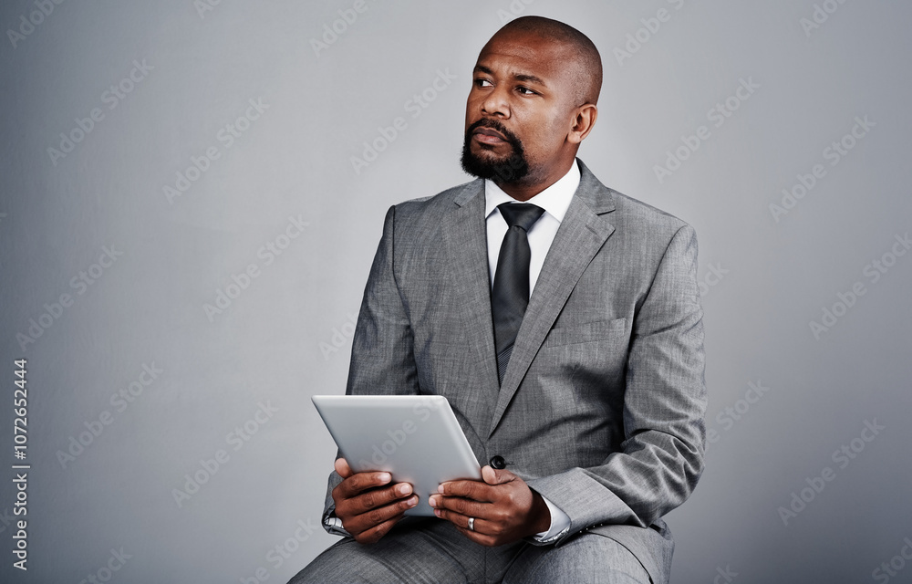 Studio, black man and business with tablet for thinking, online information or review update for case. Mockup space, male person and lawyer with digital for email feedback, justice or gray background Studio, black man and business with tablet for thinking, online information or review update for case. Mockup space, male person and lawyer with digital for email feedback, justice or gray background
