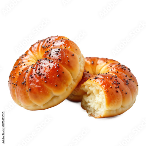 Two fried Sufganiyot, traditional Hanukkah donuts, are on isolated background. One donut is whole, other is broken, showing its soft, fluffy interior. Donuts are covered with poppy seeds and glazed. photo