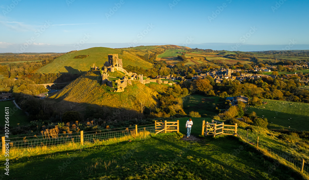 Fototapeta premium Aerial sunset view of Corfe Castle, a village and civil parish in the English county of Dorset