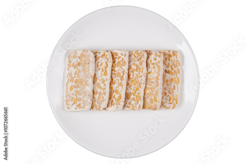 Fotografia Slices of raw tempeh on a white plate isolated transparent