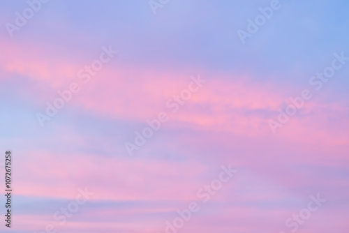 A beautiful sky tinted by the sun leaving vibrant shades of gold, pink, blue and multicolored. Clouds in the twilight evening and morning sky. Cloudy sky background in the evening, and during the day.