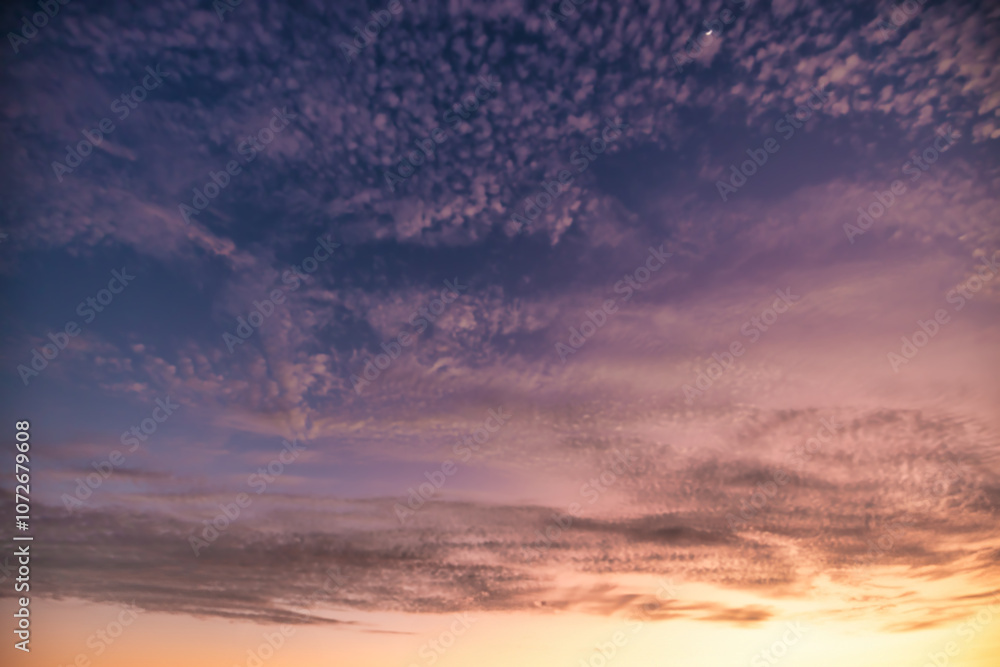 A beautiful sky tinted by the sun leaving vibrant shades of gold, pink, blue and multicolored. Clouds in the twilight evening and morning sky. Cloudy sky background in the evening, and during the day. A beautiful sky tinted by the sun leaving vibrant shades of gold, pink, blue and multicolored. Clouds in the twilight evening and morning sky. Cloudy sky background in the evening, and during the day.