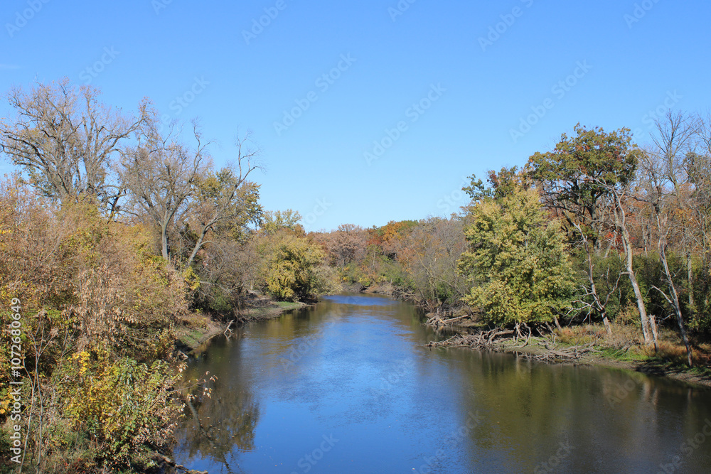 Des Plaines River in autumn with a clear sky at Camp Ground Road Woods in Des Plaines, Illinois Des Plaines River in autumn with a clear sky at Camp Ground Road Woods in Des Plaines, Illinois