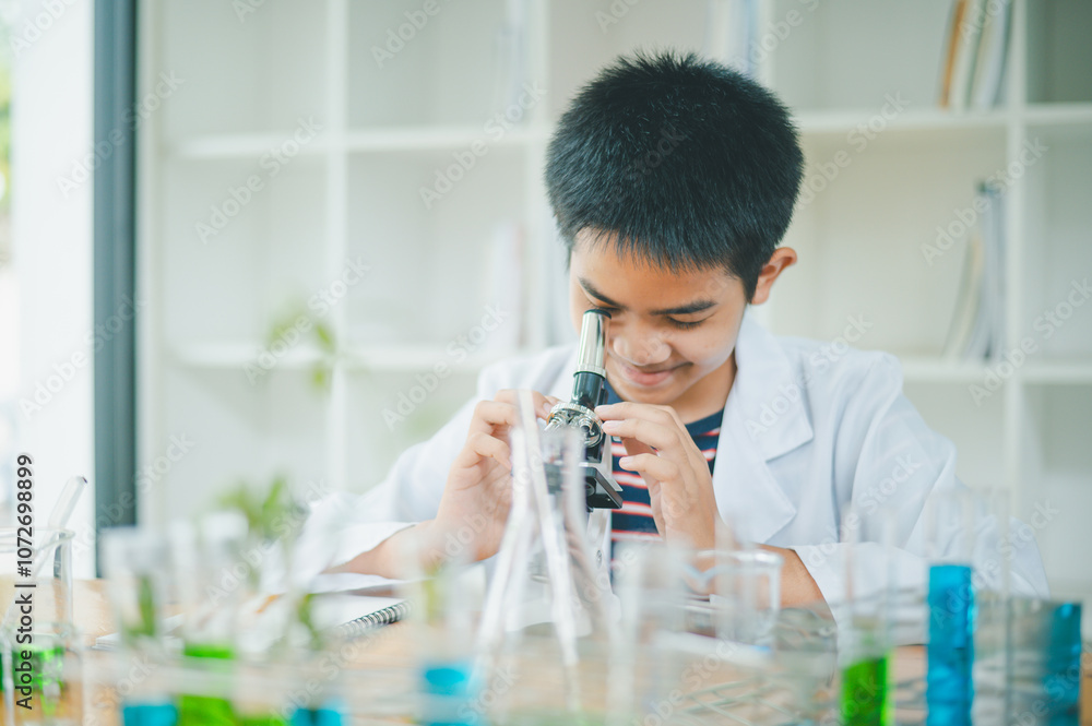 Asian male science students looking through a microscope and tests of plants in the classroom. Learning about scientific experiments on plant species. Asian male science students looking through a microscope and tests of plants in the classroom. Learning about scientific experiments on plant species.