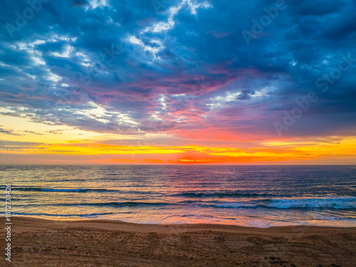 Pretty Sunrise at the seaside with rain clouds