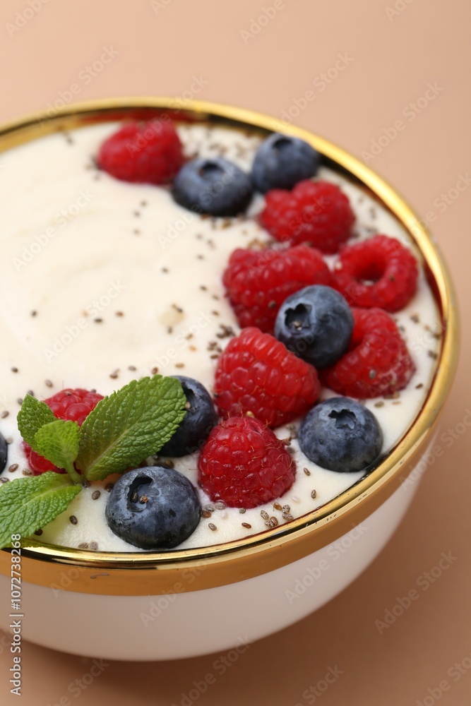 Tasty cooked semolina porridge with berries and mint on pale brown background, closeup Tasty cooked semolina porridge with berries and mint on pale brown background, closeup
