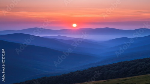 A beautiful sunrise over a mountain range with a layer of fog.