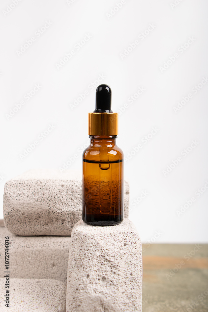 Amber Glass Dropper Bottle with Fabric Accent on Rustic Surface Amber Glass Dropper Bottle with Fabric Accent on Rustic Surface
