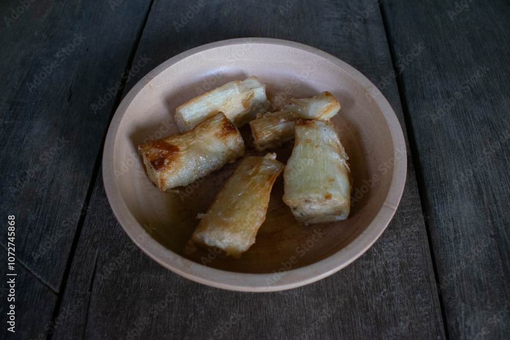 Fried cassava food served on a wooden bowl Fried cassava food served on a wooden bowl
