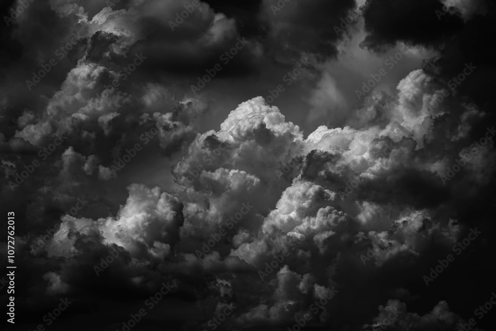 Black white dark grey sky with clouds. Dramatic background. Thunderstorm storm hurricane rain wind thunder lightning. Night moonlight. Creepy ominous frightening danger nightmare horror. Epic mystic
