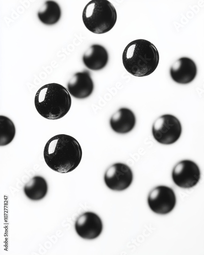 black pebbles falling on white background