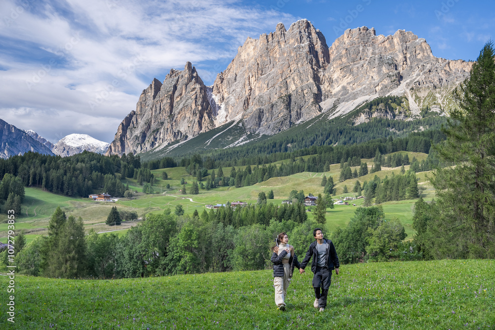 Fototapeta premium Couple enjoy view of Cortina D Ampezzo mountains landscape Dolomites, Italy.