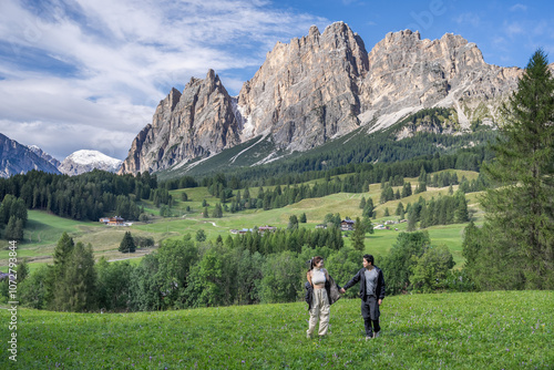 Couple enjoy view of Cortina D Ampezzo mountains landscape Dolomites, Italy. photo