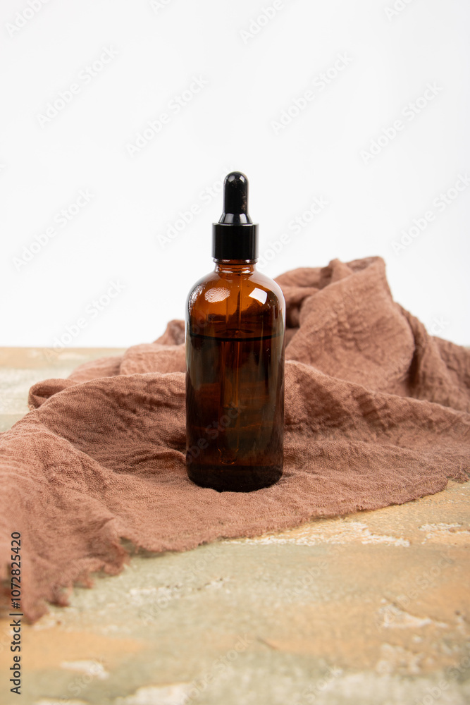 Amber Glass Dropper Bottle on Minimalist Stone Pedestal Display Amber Glass Dropper Bottle on Minimalist Stone Pedestal Display